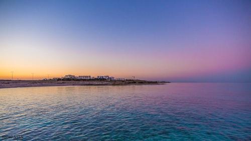 海尔盖莱Maison Eline的大海的日落,海滩背景