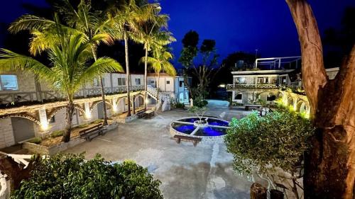 SinabacanSunbloom Beachfront Hotel and Restaurant的享有棕榈树和游泳池的别墅的空中景致