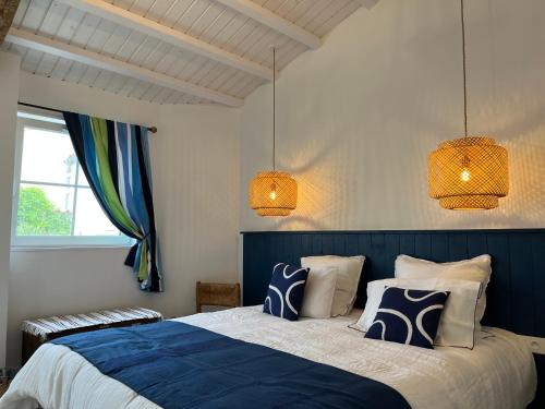 Saint-RogatienLE CLOS DE FLO 17的一间卧室配有蓝色和白色的床和2盏灯。