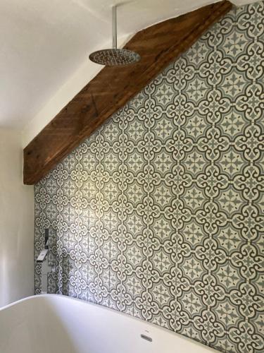 兰戈伦Avondale的一间铺有瓷砖的墙和浴缸的浴室