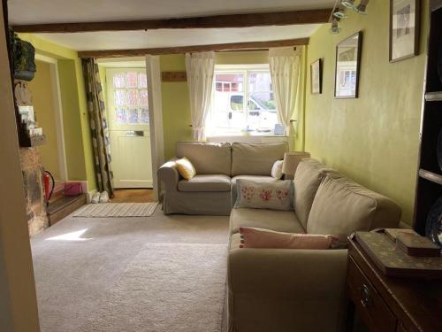 HatherleighLemon Cottage的客厅设有两张沙发和一个窗户