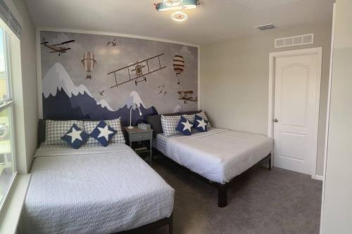 基西米Luxurious Farm Style House的卧室配有两张床,墙上挂有壁画