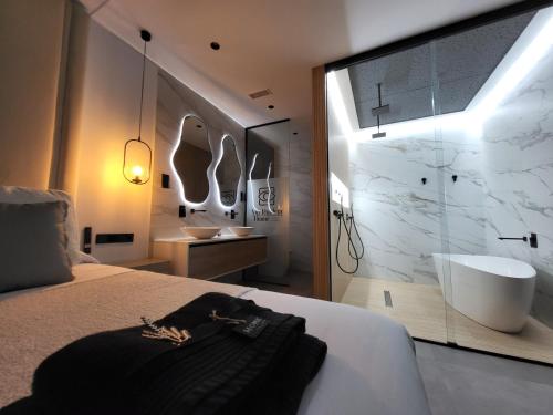 鲁伊德拉suites home ruidera的一间卧室设有带浴缸和盥洗盆的浴室