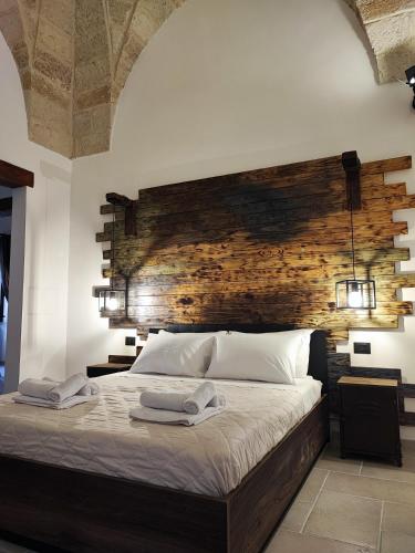 布林迪西Loft Porta Sud Civ.33的一间卧室配有一张大床和木制床头板
