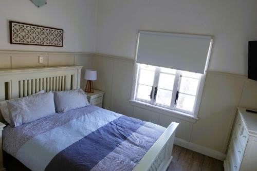 西南岩Christina Cottage的一间卧室设有一张床和一个窗口