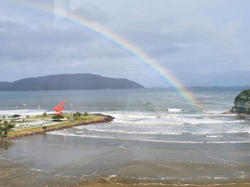 桑托斯Aqui é pé na areia的海面上的一个彩虹,海滩