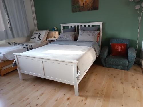 巴黎Super appartment at Paris的卧室配有一张白色大床和一把椅子