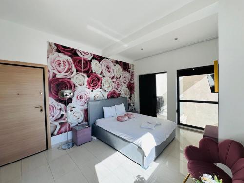 马马亚Riviera Studios的卧室墙上挂着玫瑰壁画