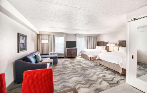 亚特兰大汉普顿酒店加亚特兰大广场套房的酒店客房,设有两张床和一张沙发