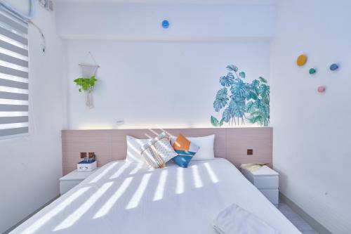 恒春古城海海天光的卧室配有带枕头的大型白色床