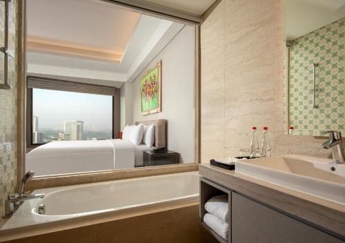 塞尔蓬Trembesi Hotel的带浴缸、水槽和床的浴室