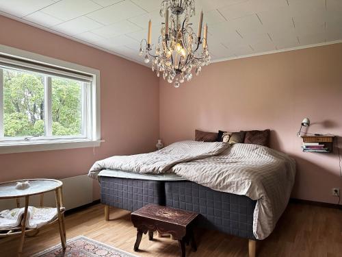 NåsWilderness cabin in Nas near the Vasterdal River的一间卧室配有一张床和一个吊灯