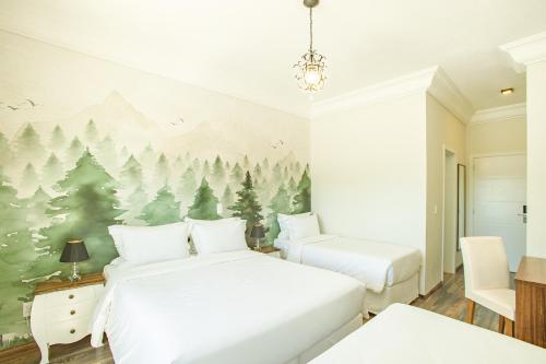 坎波斯杜若尔当Altitude Lodge Hotel的一间卧室设有两张床,并拥有一幅树木壁画