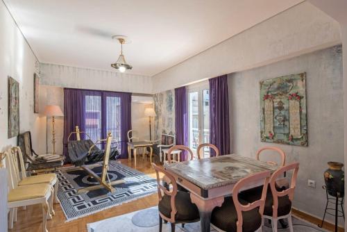 雅典Visionery apt in Pagrati的客厅配有木桌和椅子