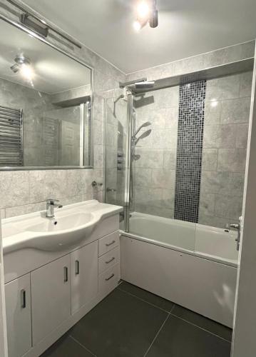 贝肯翰姆Modern Stylish Two Bedroom Apartment的一间带水槽、浴缸和淋浴的浴室
