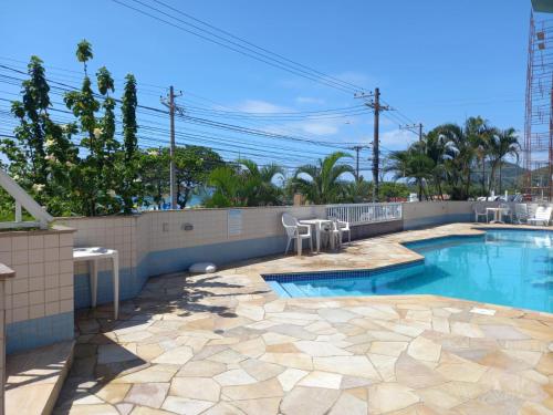 乌巴图巴Apartamento de Frente para o Mar的一个带庭院和围栏的游泳池