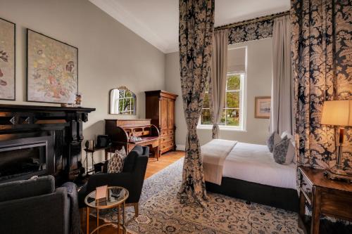 Hagley昆比庄园酒店的酒店客房配有一张床和一个壁炉。