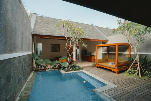 金巴兰Villa Bulan Bali的房屋前有游泳池的房子