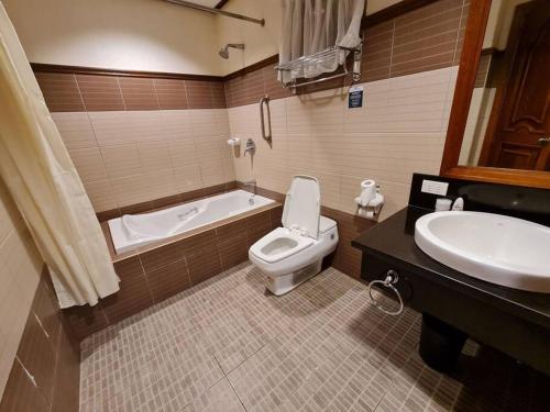 利帕Luxury 1 BR Suite Malarayat Lipa的带浴缸、卫生间和盥洗盆的浴室