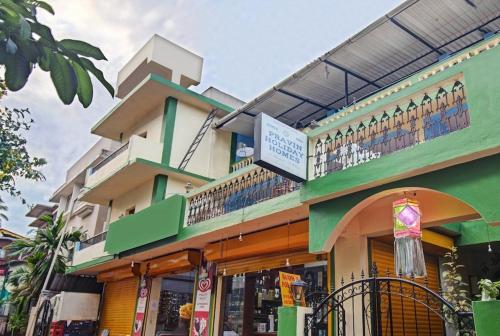 卡兰古特Super OYO Pravin Holiday Homes的一座绿色建筑,上面设有阳台
