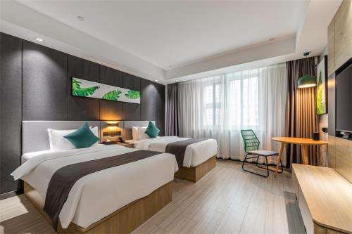 泰州尚客优品泰州姜堰区亚美国际酒店的酒店客房设有两张床和一张桌子。