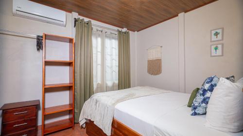 福尔图纳Cerro Chato's House的一间卧室设有一张床和一个书架
