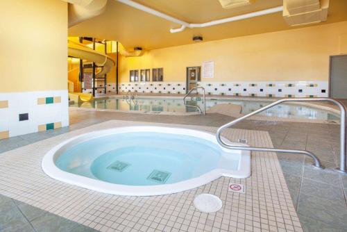 特鲁罗速8特鲁罗酒店的带淋浴的浴室设有大浴缸