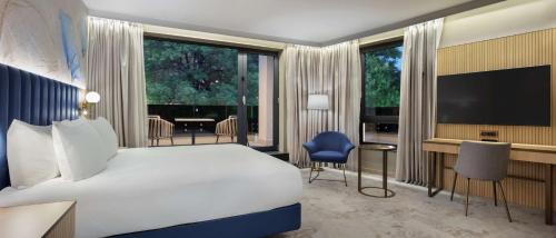 普罗夫迪夫Doubletree By Hilton Plovdiv Center的酒店客房,配有床和电视