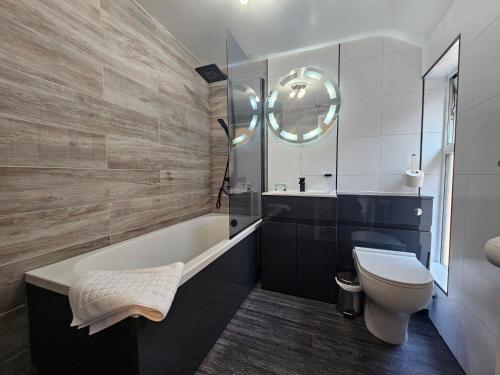 斯塔福德ABBEY HOTEL的带浴缸、卫生间和盥洗盆的浴室