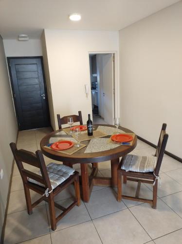 卢汉德库约Montaña Sol Malbec的一间带木桌和椅子的用餐室