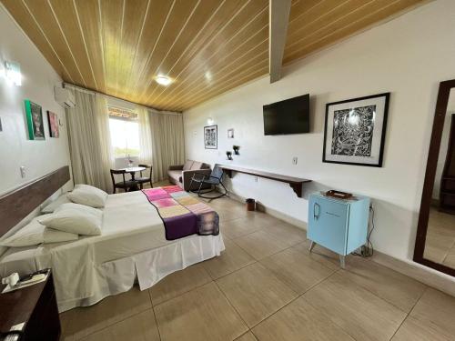 阿雷亚Hotel Fazenda Triunfo的配有一张床和一张书桌的酒店客房