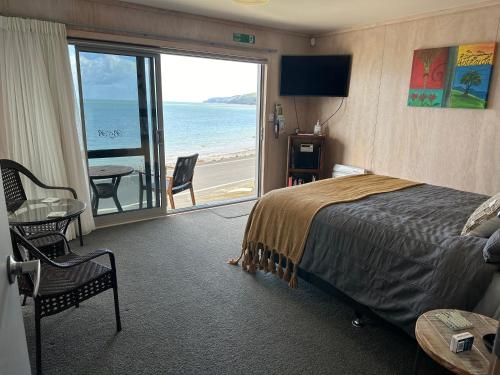 TapuTe Mata Bay Seaviews的一间卧室配有一张床,享有海景