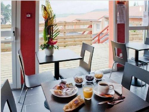Saint-Georges康塔尔酒店的一张桌子,上面有早餐食品和饮料