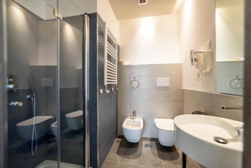 丽都迪奥斯蒂亚Ostia Holiday Sunset的浴室设有2个卫生间、水槽和淋浴。
