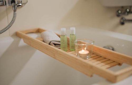 茨维考Zentral Smart Apartment的浴室内带毛巾和蜡烛的木制架子