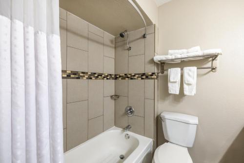 罗斯威尔罗斯韦尔戴斯酒店的带浴缸、卫生间和淋浴的浴室。