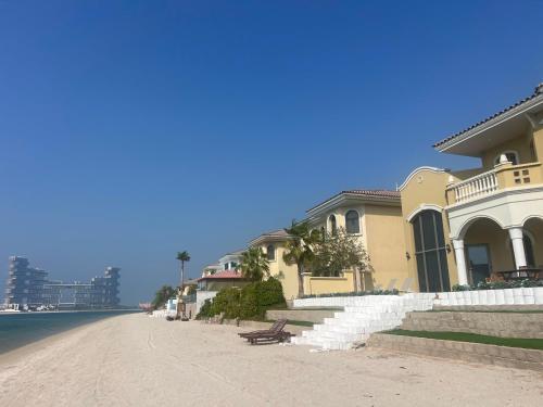 迪拜The Atlantis Hotel View, Palm Family Villa, With Private Beach and Pool, BBQ, Front F的海边道路边的房子