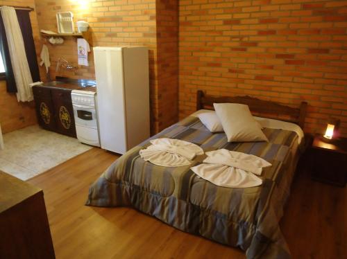 圣弗朗西斯科-迪保拉Pousada Parque da Cachoeira的一间卧室配有一张床,上面有两条毛巾