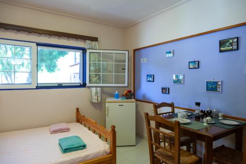 瓦西利卡Liakos' Apartments的客房设有床、桌子和窗户。