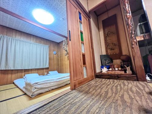 泉佐野比格汉姆之家住宿加早餐旅馆的一间房间,房间内设有一扇门和一张床