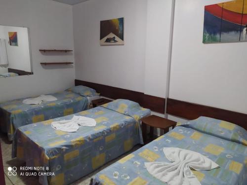 贝伦Hotel Paraiso Belém的一间医院间,配有两张床和镜子