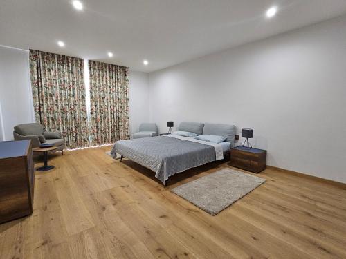 帕切维拉Stunning Seafront Portomaso Apartment的一间卧室配有一张床和一把椅子