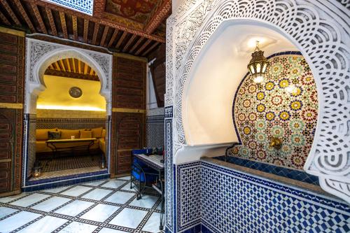 非斯Riad Dar Omar的一间设有摩洛哥式图案墙壁和摩洛哥式瓷砖的房间