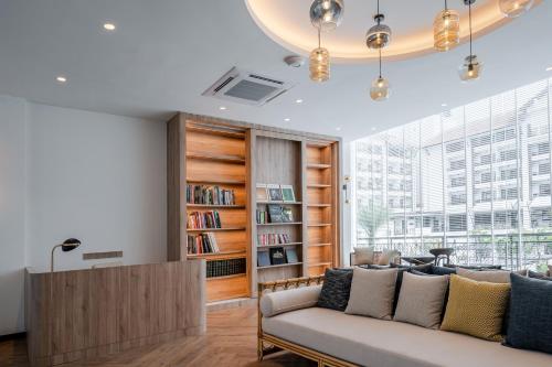 甲抛峇底Bertam Resort,Penang的带沙发和书架的客厅
