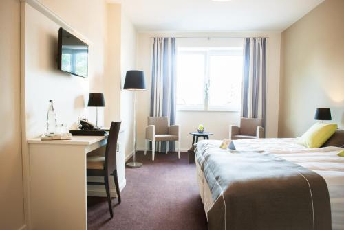 Espelkamp-Mittwald绿色花环酒店的酒店客房配有两张床和一张书桌