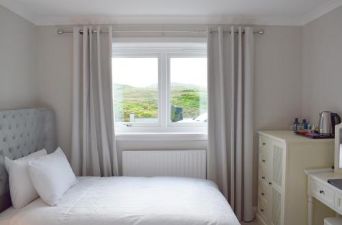 LeverburghGrimisdale Guest House的一间卧室设有一张床和一个窗口