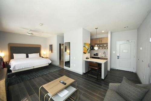 博蒙特博蒙特希尔顿惠庭套房酒店的酒店客房带一张床和一个厨房