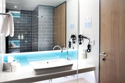 菲尔特Holiday Inn Express Fürth, an IHG Hotel的一间带水槽和镜子的浴室