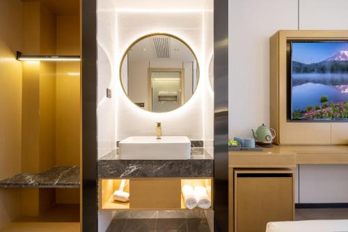 北京东方圣达酒店（近中日友好医院-鸟巢水立方-雍和宫-南锣古巷）的一间带水槽和镜子的浴室