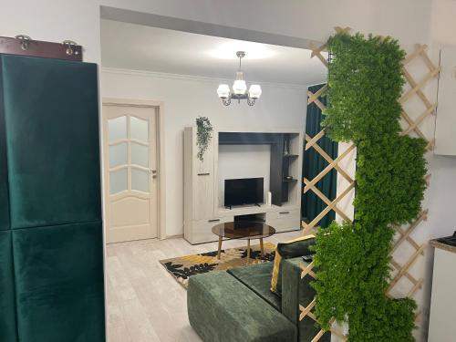 巴克乌Green Apartament的客厅设有绿色沙发和壁炉